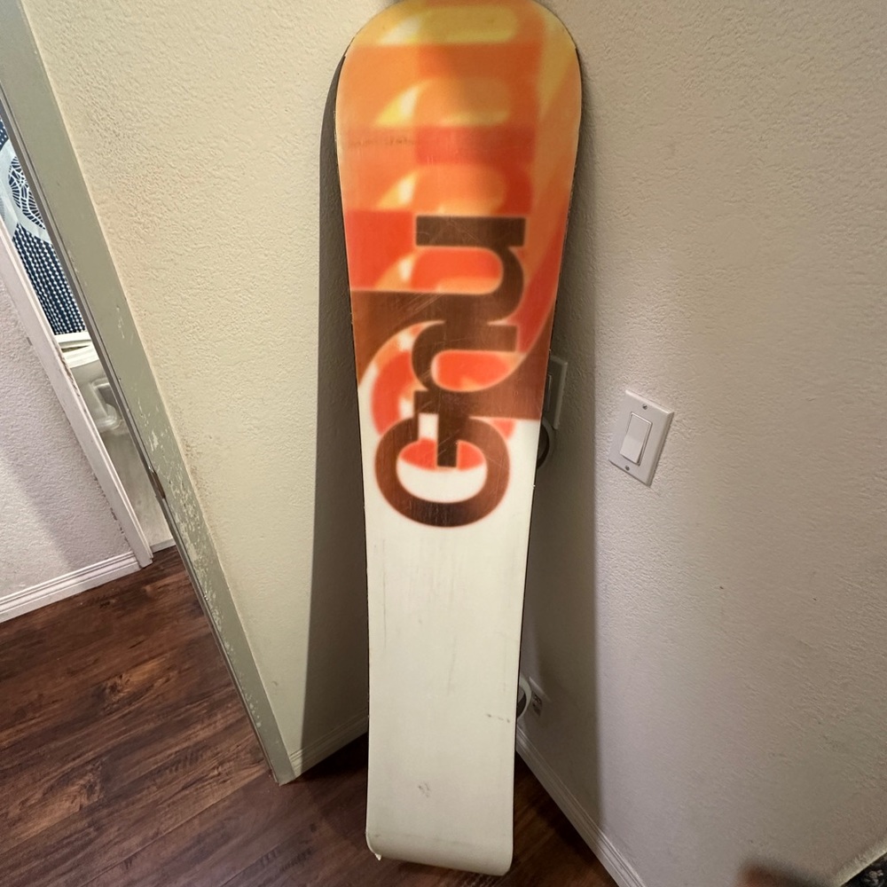 GNU Snowboard with Orange Fade Graphic. Used GNU SNOWBOARDING